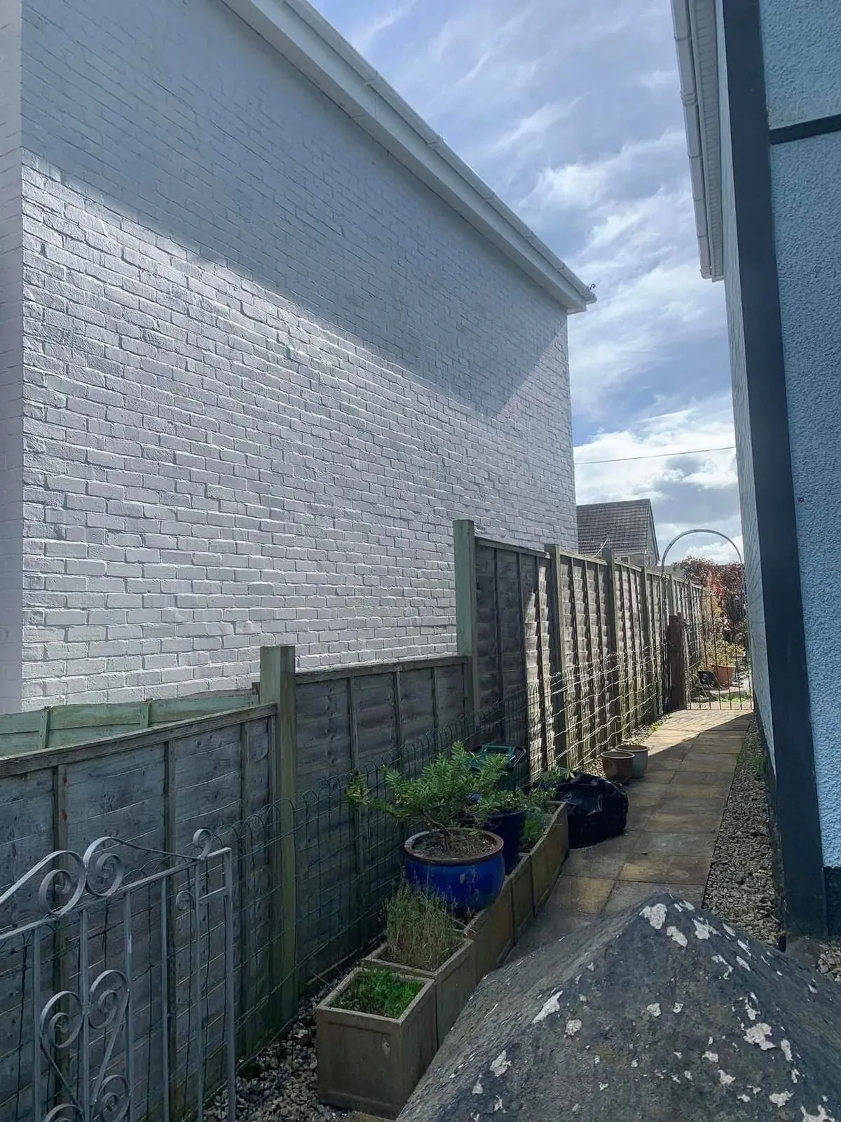 Freshly painted brick wall after preparation and masonry paint in Seaton